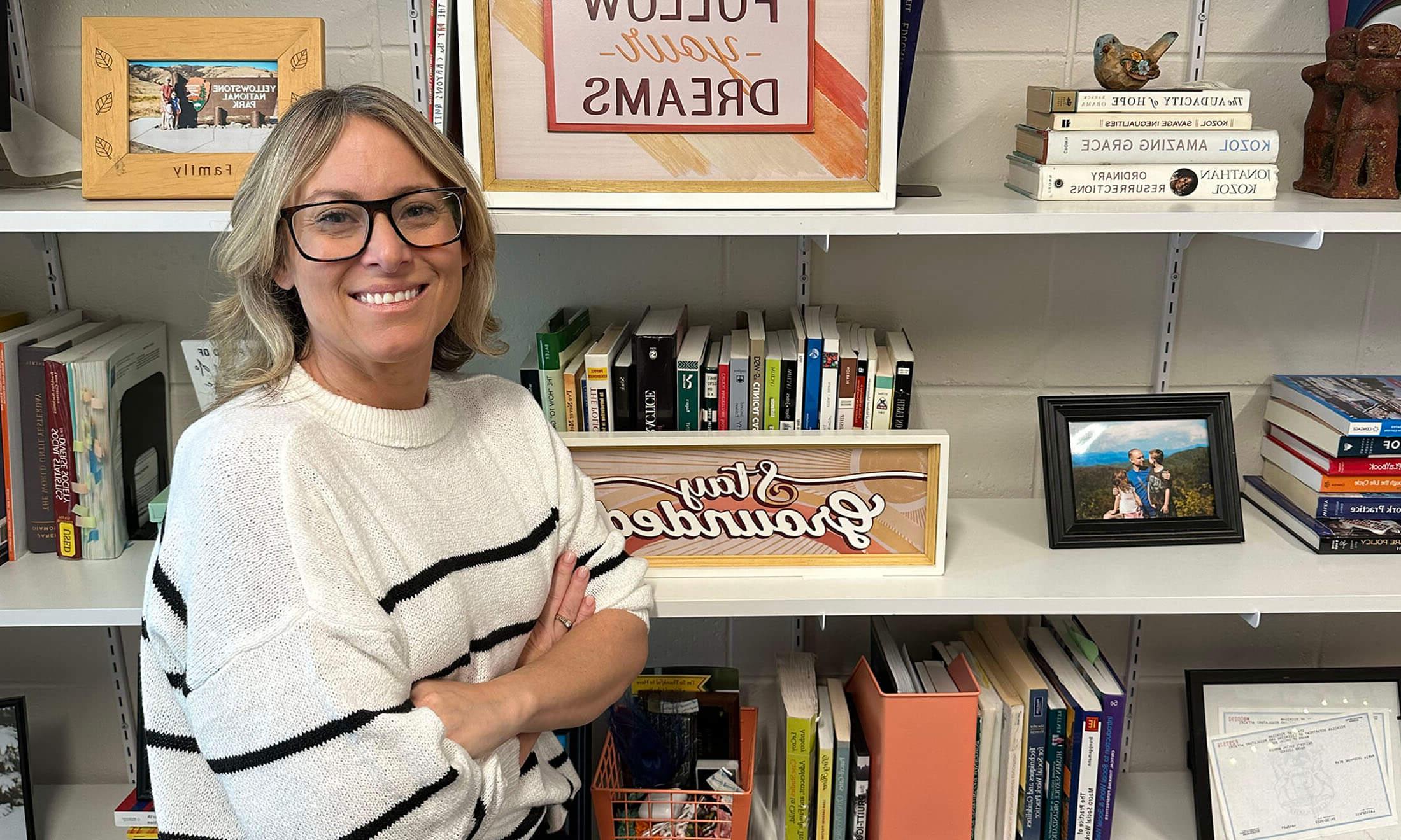 Woman standing in front of bookcase