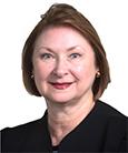 Headshot Woman in Black top with short brown hair. Academic Advisor